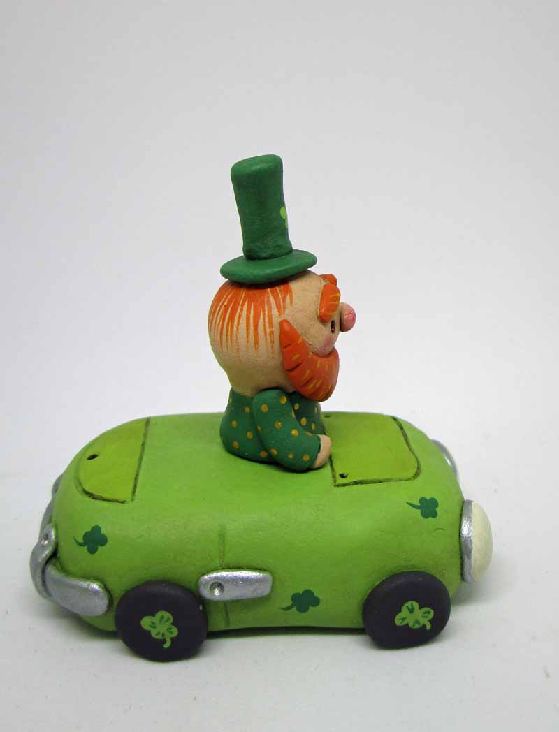St. Patrick's day tiny leprechaun riding in a green clover decor