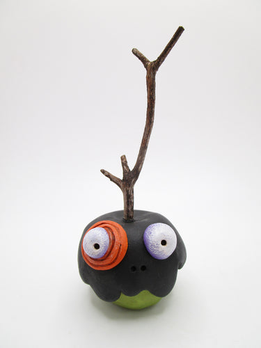Halloween folk art black poison candy apple with bug eyes