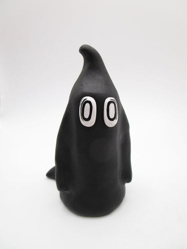 Halloween folk art ghost in black with empty eyes