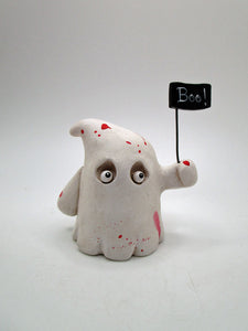 Halloween bloody ghost with "BOO!" sign