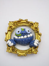 Monster art gilded gold frame with blue monster and wacky teeth