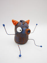 Monster folk art dark blue and orange snoot monster with bendable arms and legs