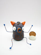 Monster folk art dark blue and orange snoot monster with bendable arms and legs