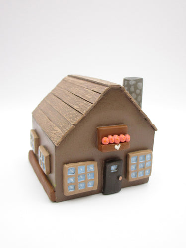 Wood house brown with windows shrubs and chimney  misc