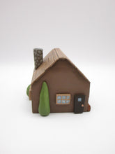 Wood house brown with windows shrubs and chimney  misc