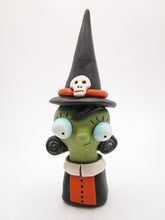 Halloween witch bust in orange and black with skull on hat