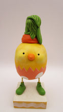 Easter chick with carrot top hat and broken easter egg bottom