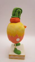 Easter chick with carrot top hat and broken easter egg bottom