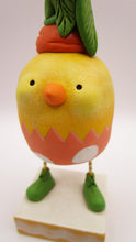 Easter chick with carrot top hat and broken easter egg bottom