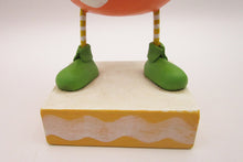 Easter chick with carrot top hat and broken easter egg bottom