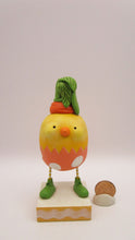 Easter chick with carrot top hat and broken easter egg bottom