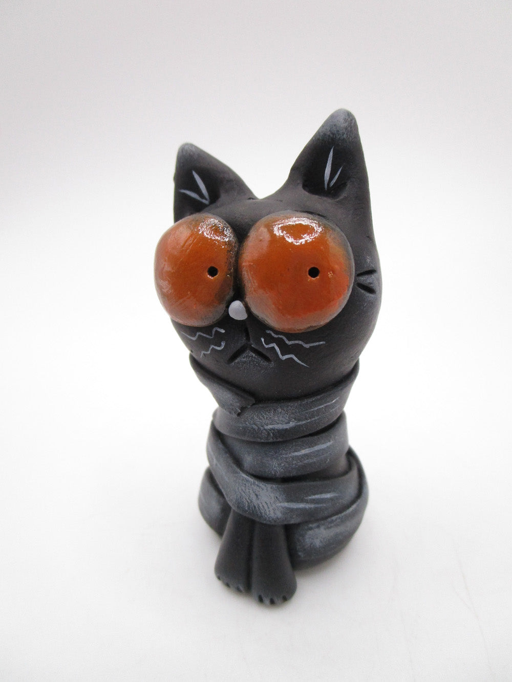 Little Halloween black cat mummy with huge orange eyes