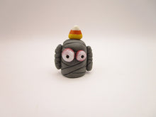 Halloween folk art small mummy man a candy corn on its head