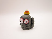 Halloween folk art small mummy man a candy corn on its head