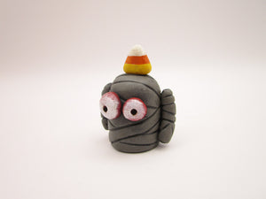 Halloween folk art small mummy man a candy corn on its head