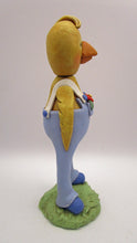 Easter or Spring folk art chick wearing light blue overalls