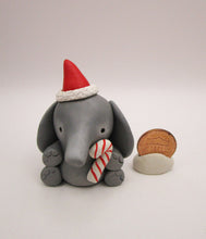 Christmas folk art small elephant with Santa hat