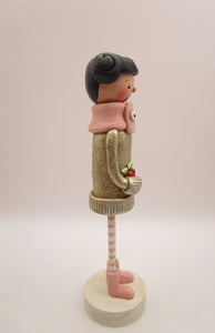 Christmas folk art girl in champagne shimmer sweater with wood legs
