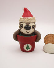 Christmas small sloth in pot wearing Santa hat