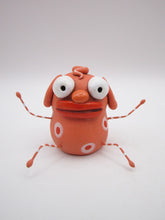 Monster folk art little peach colored monster with bendable arms and legs