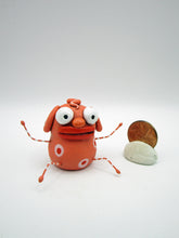Monster folk art little peach colored monster with bendable arms and legs