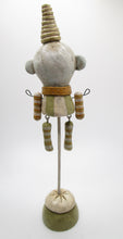 Fine crackle wacky character man in colors of sage and cream dangling arms and legs