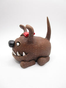 Wacky character cute and frightful big brown dog with spiked teeth