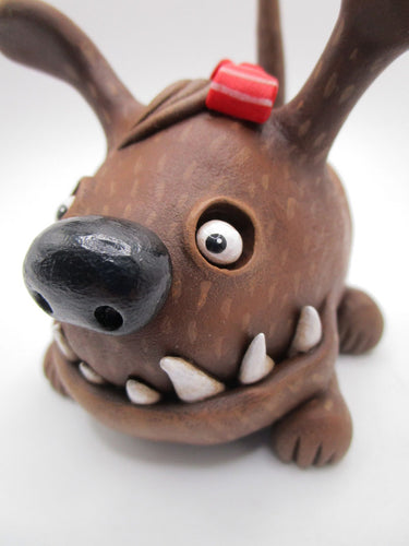 Wacky character cute and frightful big brown dog with spiked teeth