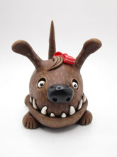 Wacky character cute and frightful big brown dog with spiked teeth