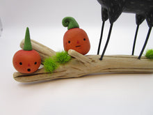 Halloween folk art black dog and crow on driftwood with pumpkins