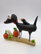 Halloween folk art black dog and crow on driftwood with pumpkins