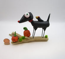 Halloween folk art black dog and crow on driftwood with pumpkins