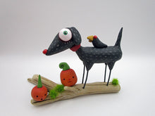 Halloween folk art black dog and crow on driftwood with pumpkins