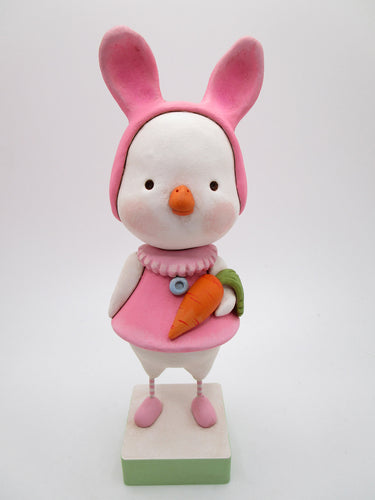 Easter duck wearing a pink bunny hat