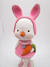 Easter duck wearing a pink bunny hat