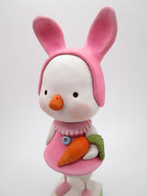 Easter duck wearing a pink bunny hat