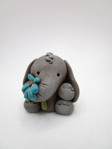 Little spring time gray elephant with flower