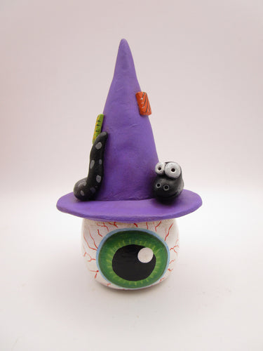 Halloween folk art eyeball wearing witch hat with snake