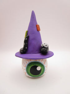 Halloween folk art eyeball wearing witch hat with snake