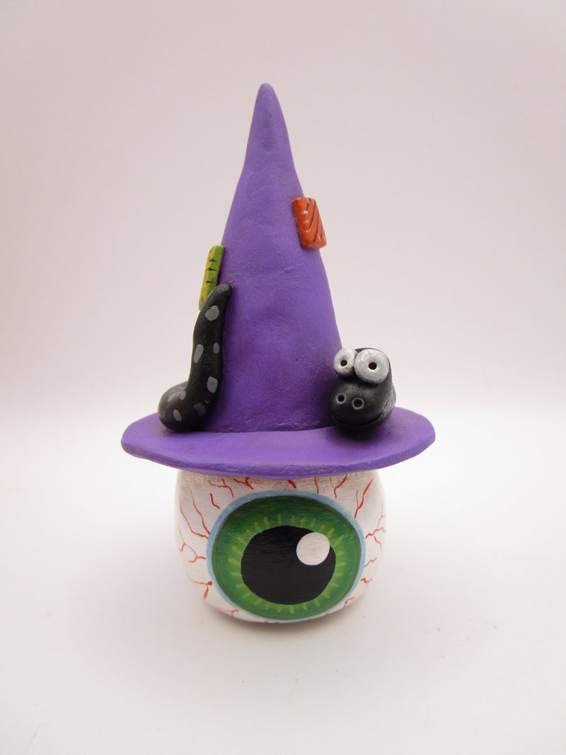Halloween folk art eyeball wearing witch hat with snake