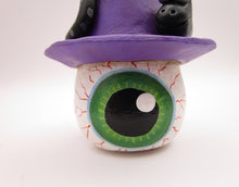 Halloween folk art eyeball wearing witch hat with snake