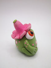 Spring folk art frog wearing pink flower hat