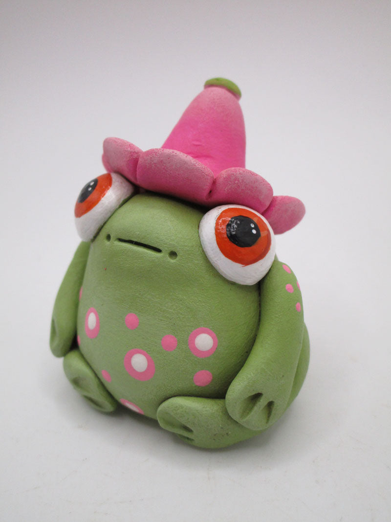 Spring folk art frog wearing pink flower hat