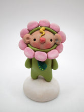 Tiny kid spring time folk art wearing a flower costume small kid Easter