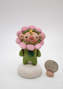 Tiny kid spring time folk art wearing a flower costume small kid Easter