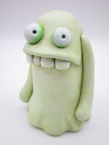 Halloween goofy ghost with 4 teeth and undertone of lime color under white