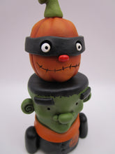 Halloween folk art Frankenstein and masked pumpkin man