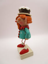 Christmas folk art ELF character with fruitcake platter on his head