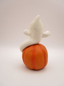 Halloween folk art cute ghost sitting on surprised pumpkin