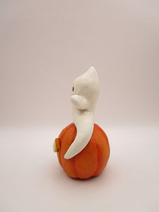 Halloween folk art cute ghost sitting on surprised pumpkin